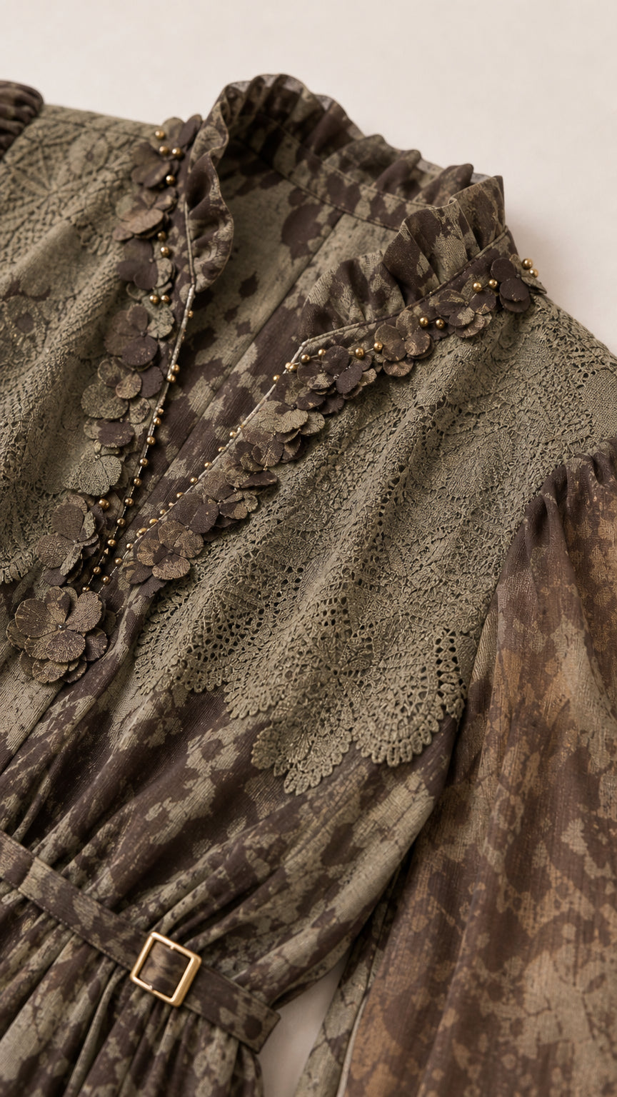 Close up of bodice details and lace trim on olive dress