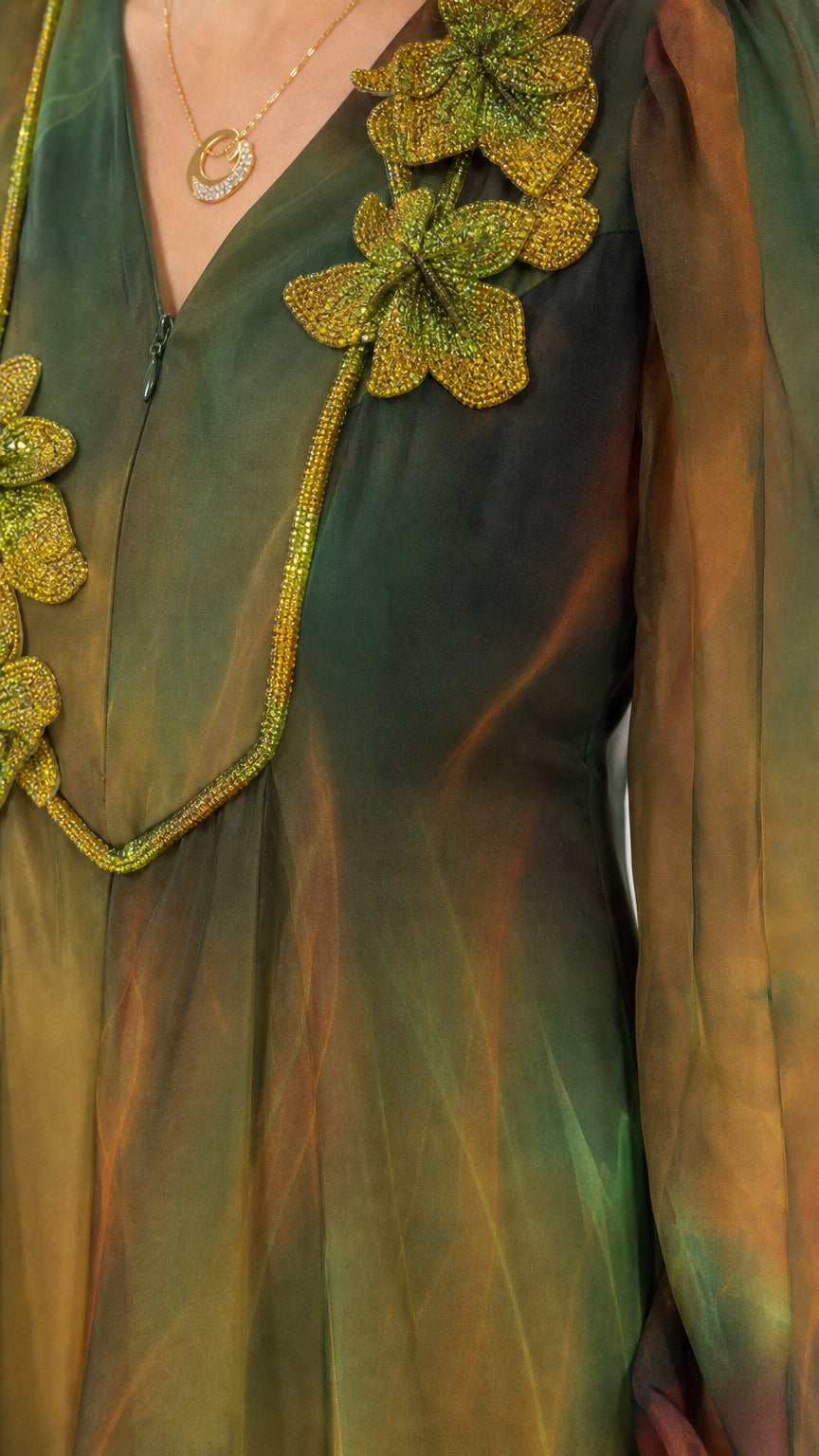 Close-up of beaded floral appliqué detail on V-neck chiffon dress