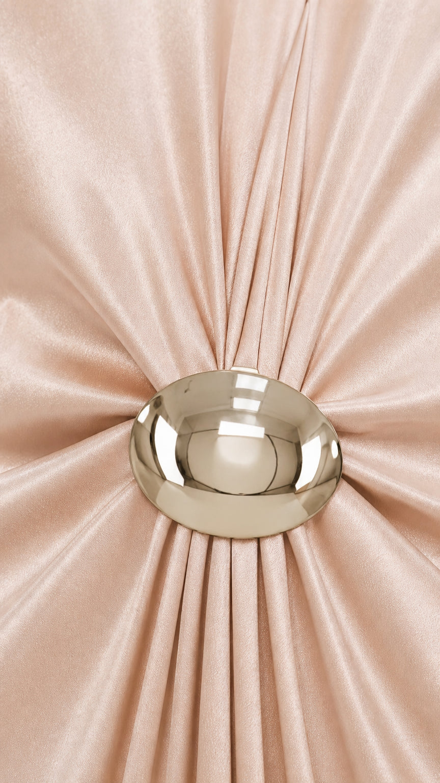 Close-up detail of the gathered pleats and polished domed metallic ring accent