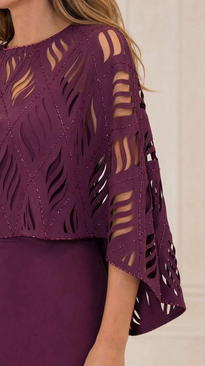 Close-up detail of the cutout patterned capelet