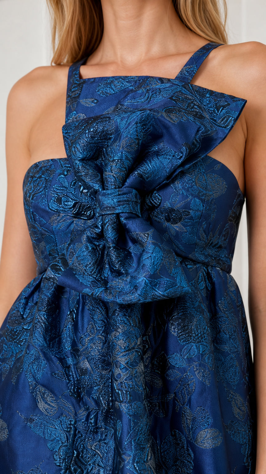 Close-up of square neckline and structural front bow detail