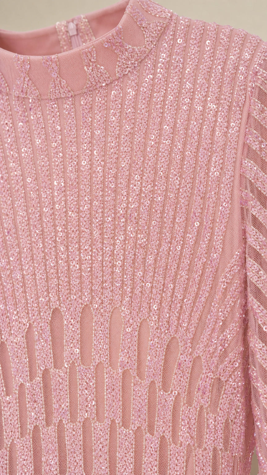 Close-up detail of mock neck and vertical sequin pattern on pink dress