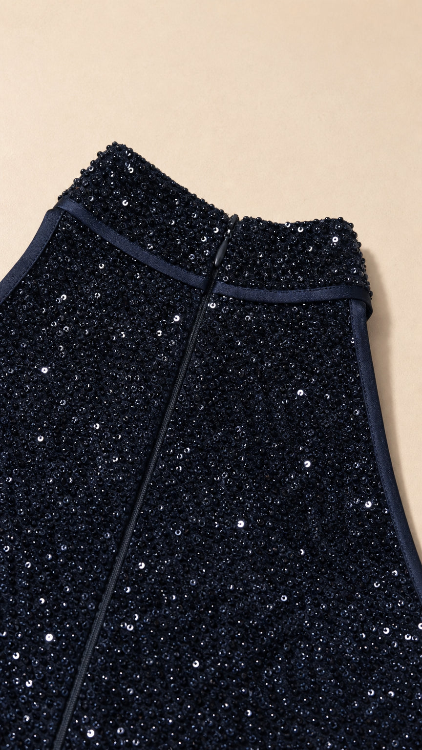 Close-up detail of navy sequin fabric and zipper construction