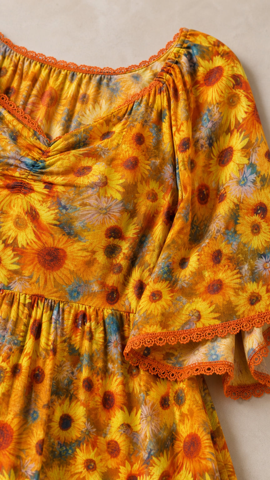 Close-up detail of neckline and flutter sleeve with delicate lace trim on floral fabric