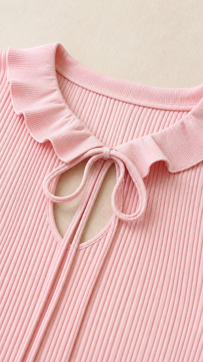Close-up detail of ruffle collar and tie-front closure