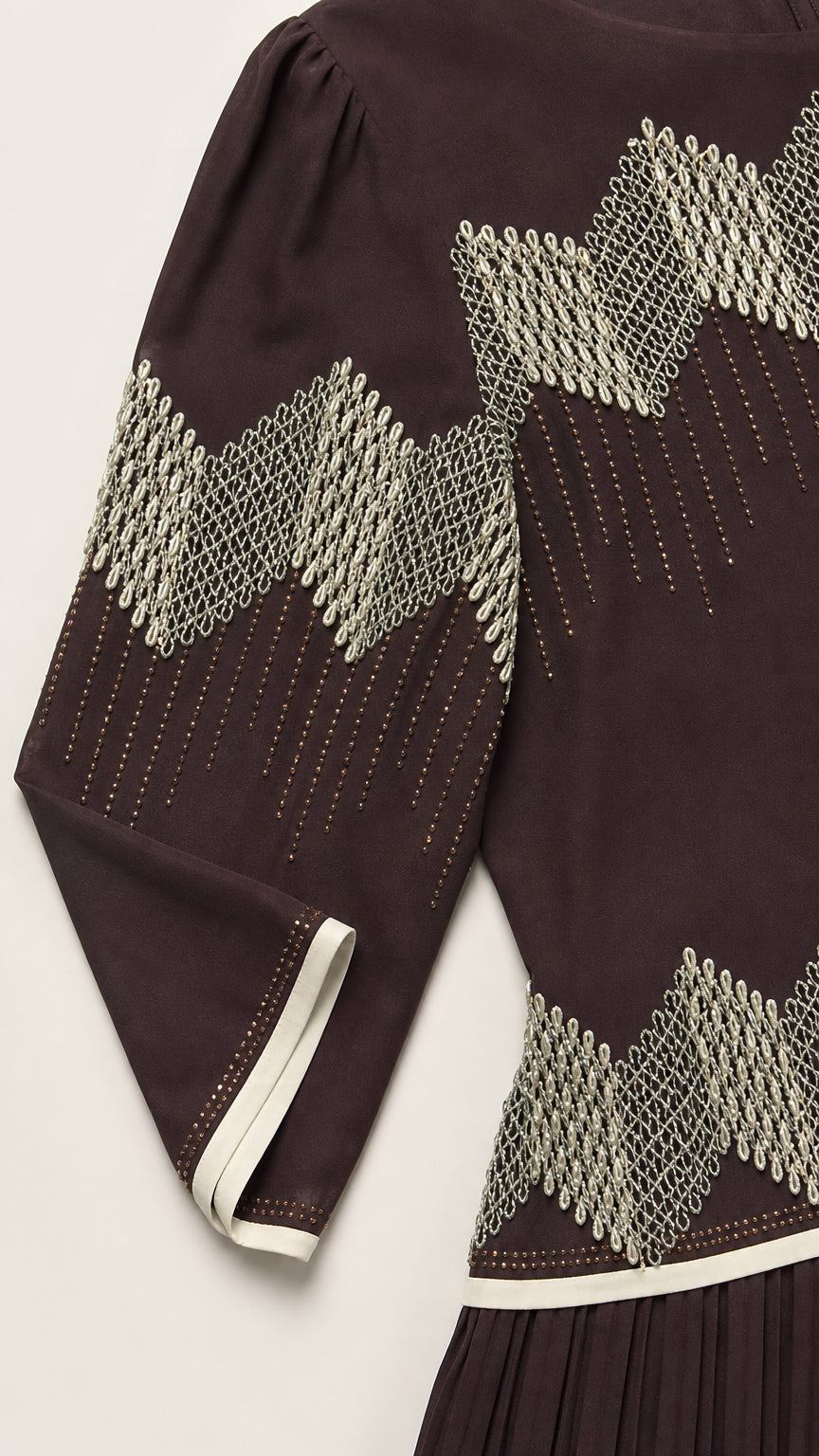 Close-up of the dress geometric decorative band and contrast trim