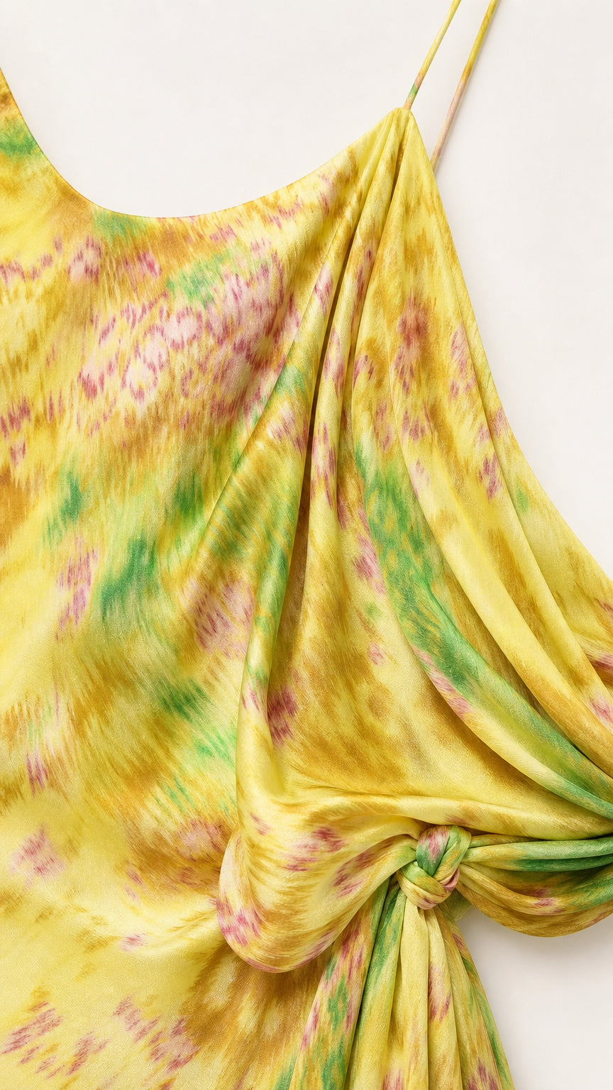 Close-up detail of silky watercolor fabric and tied drape accent