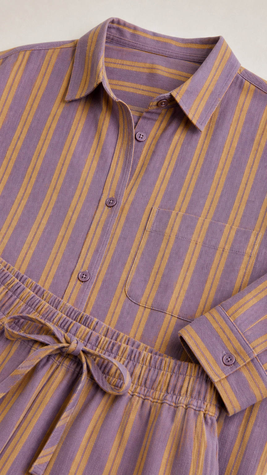 Close-up detail of purple striped shirt collar and pants drawstring waistband