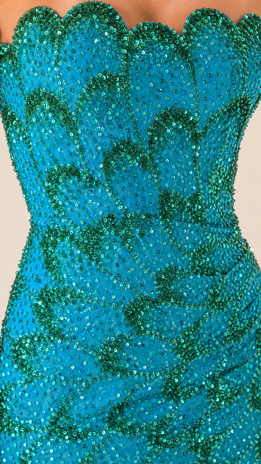 Close-up detail of scalloped neckline and sequin pattern on teal gown