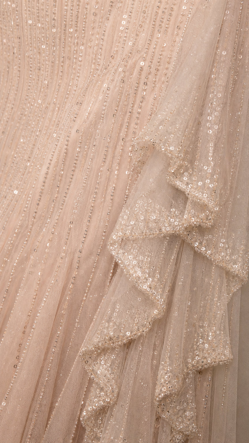 Close-up detail of textured sequins and ruffled hem