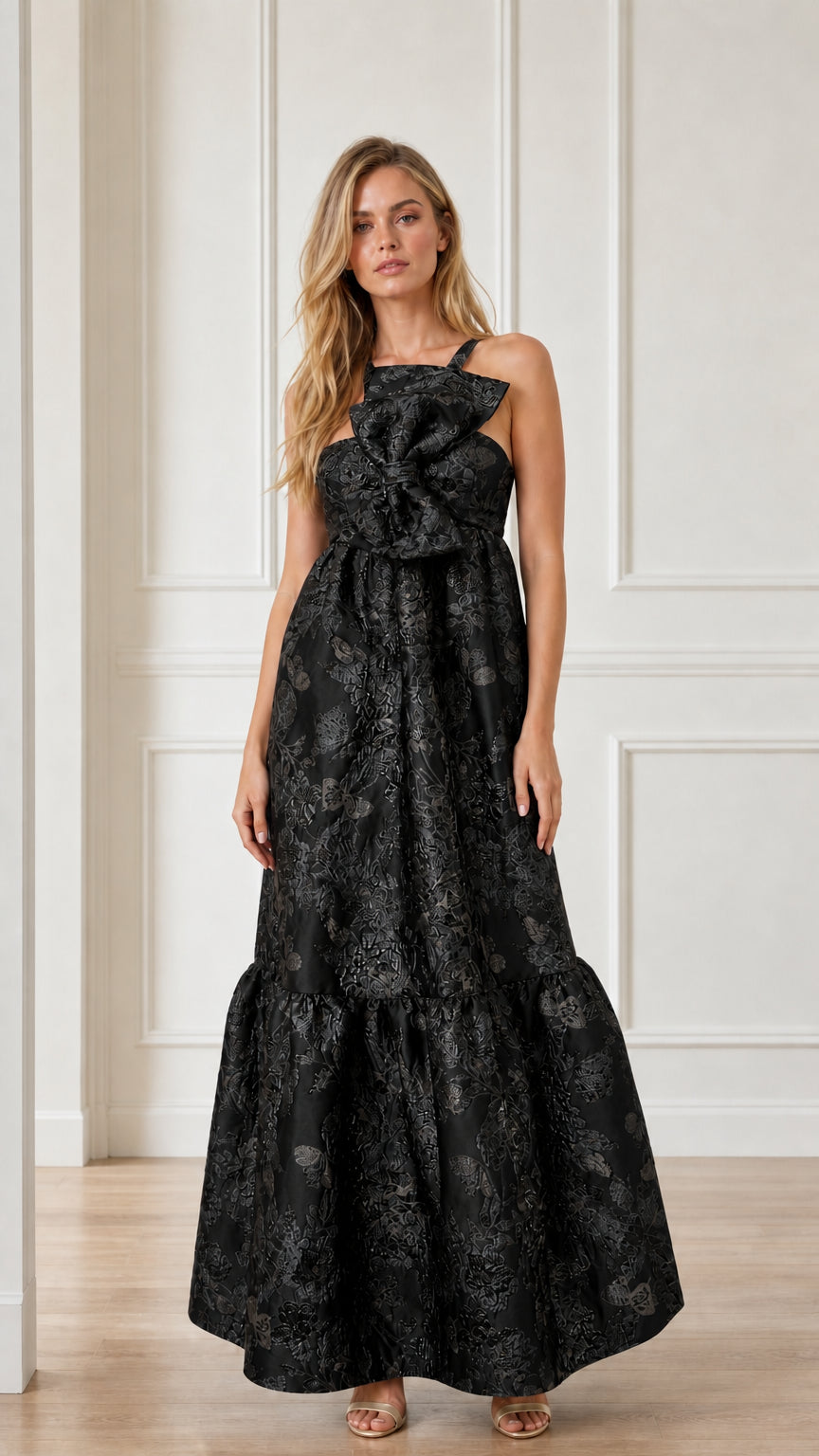 Front view of black brocade maxi dress with bow