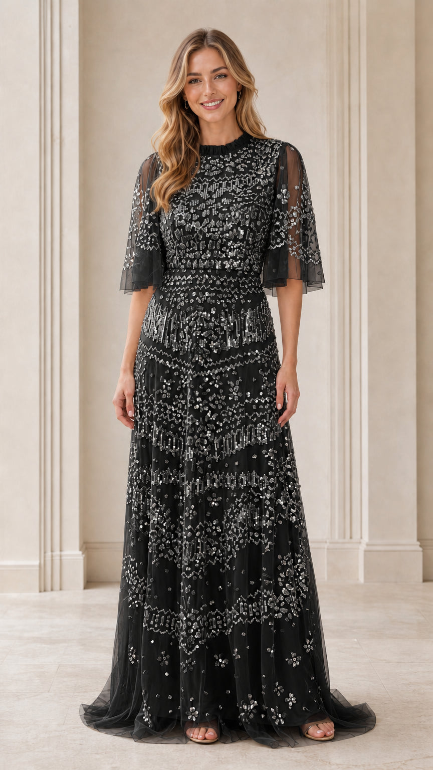 Front view of model wearing black sequin evening gown