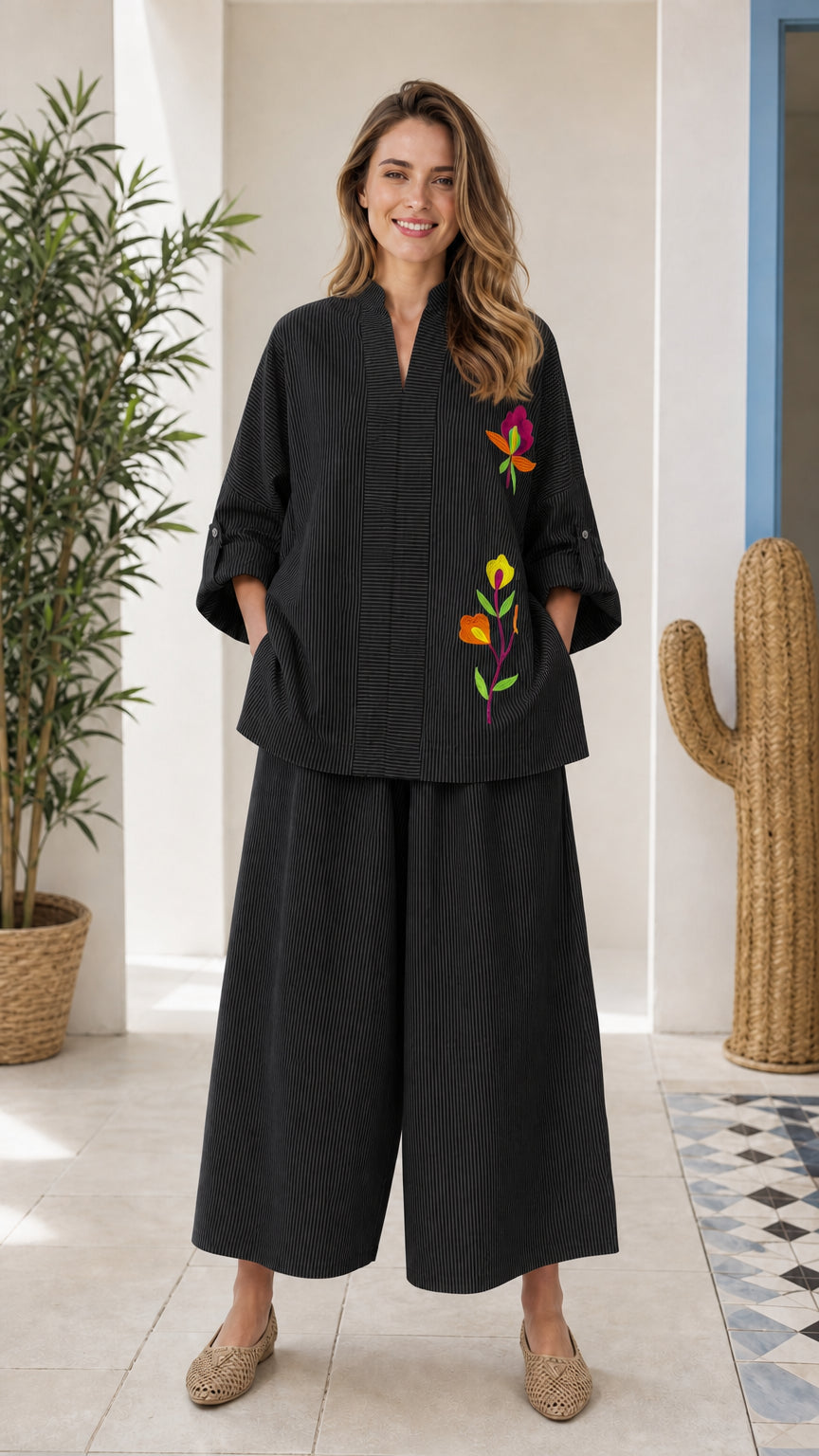 Front view of woman wearing black embroidered two-piece set