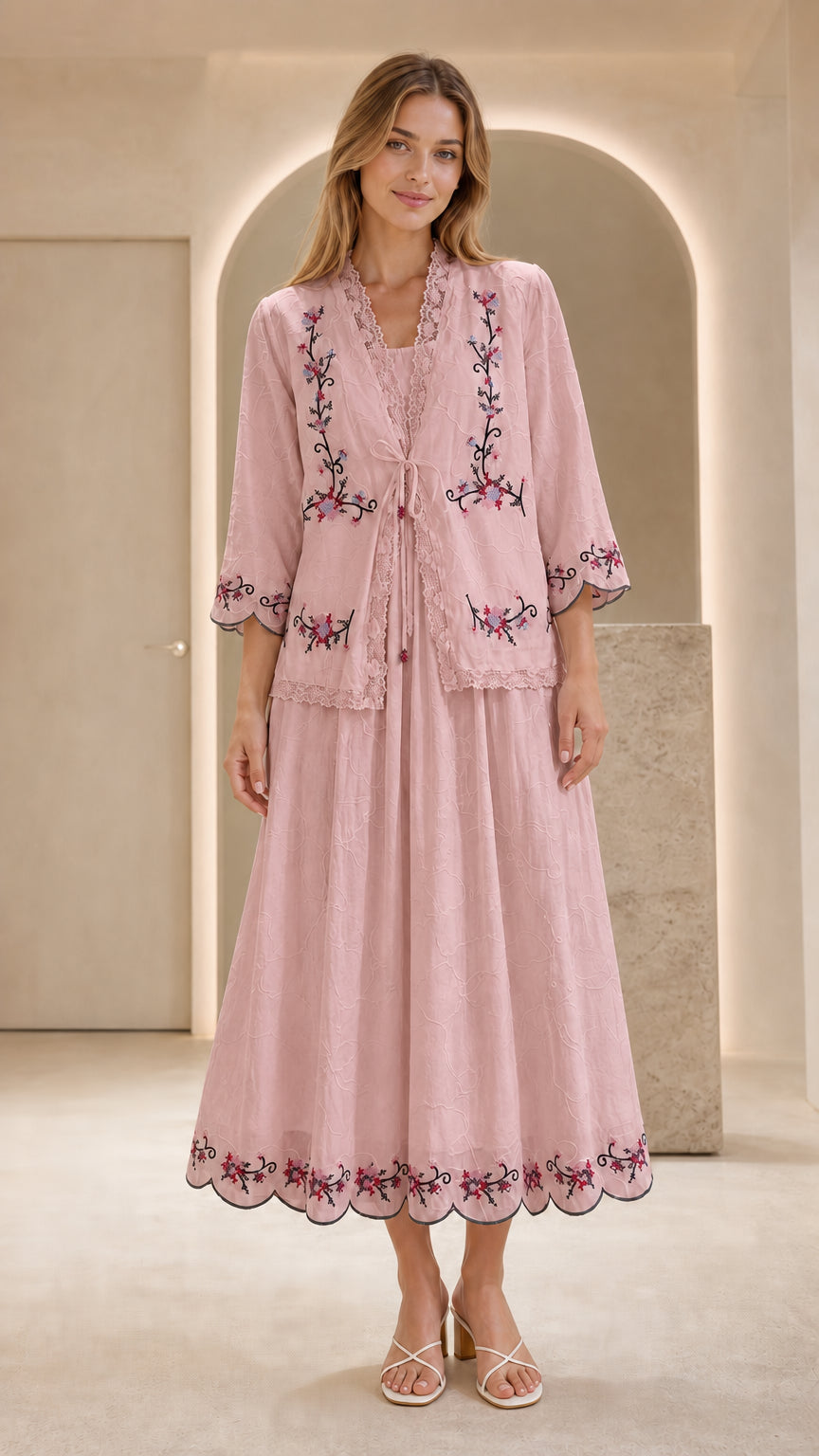 Front view of model wearing pink embroidered two-piece dress set