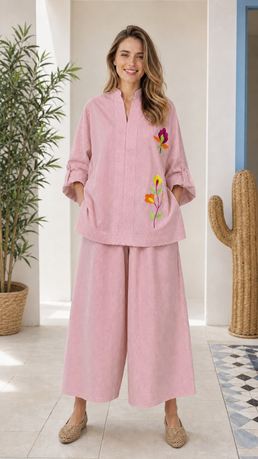 Front view of woman wearing pink embroidered two-piece set