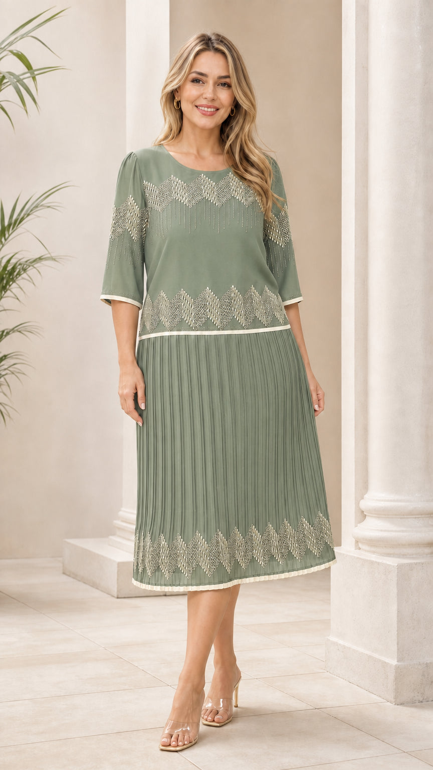 Sage green geometric pleated midi dress shown from the front