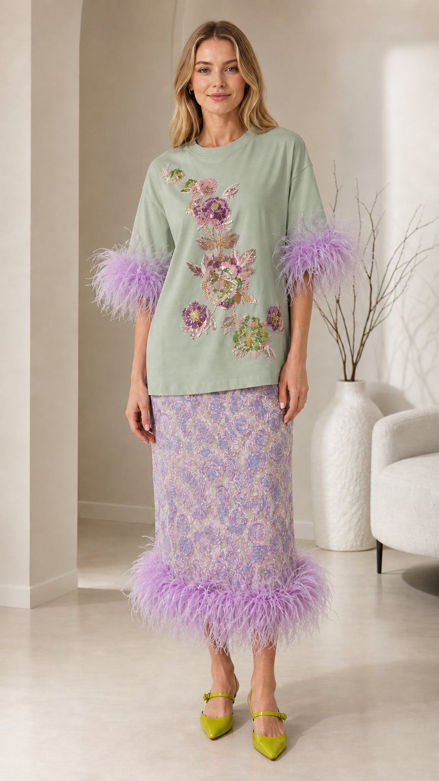 Front view of sage green color variant with feather trim