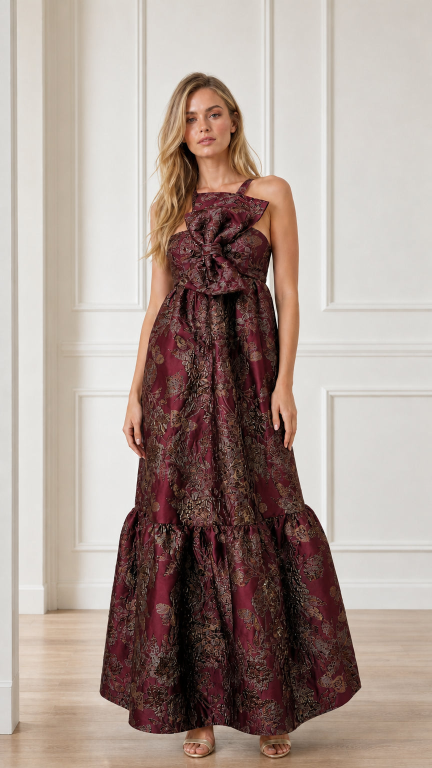 Front view of burgundy brocade maxi dress with bow