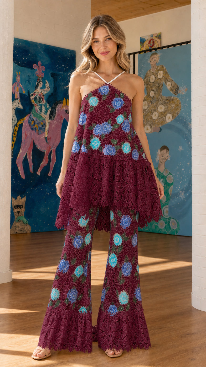 Front view of burgundy floral embroidered halter top and flared pants set