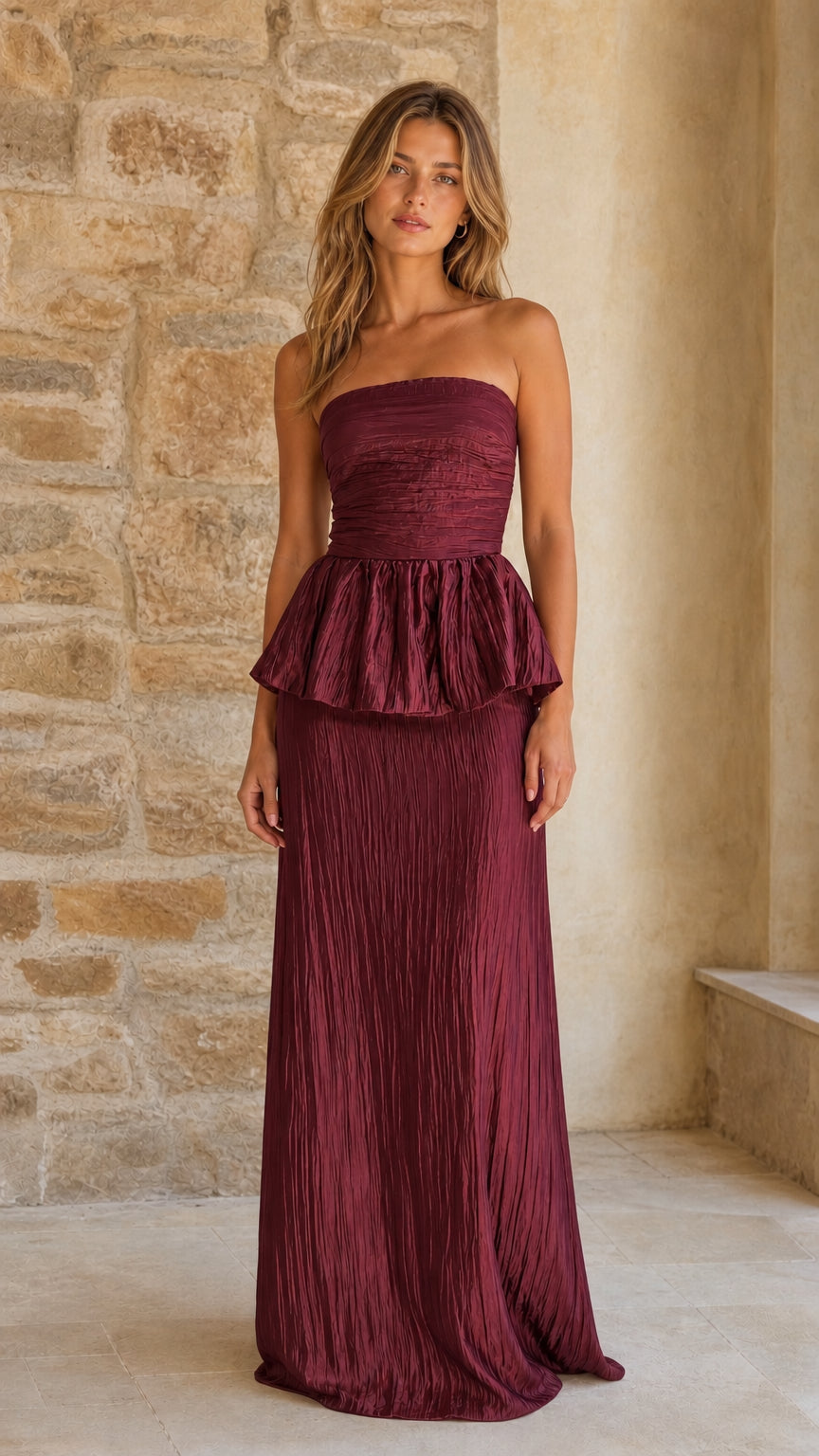Model wearing burgundy strapless pleated maxi dress