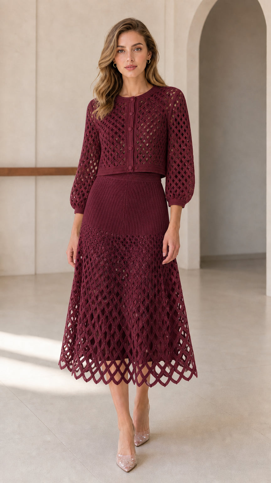 Model wearing burgundy open-knit cardigan and midi skirt set