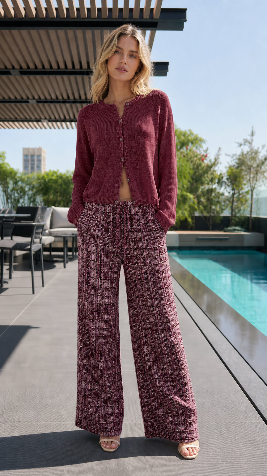 Model wearing burgundy cardigan and matching patterned pants