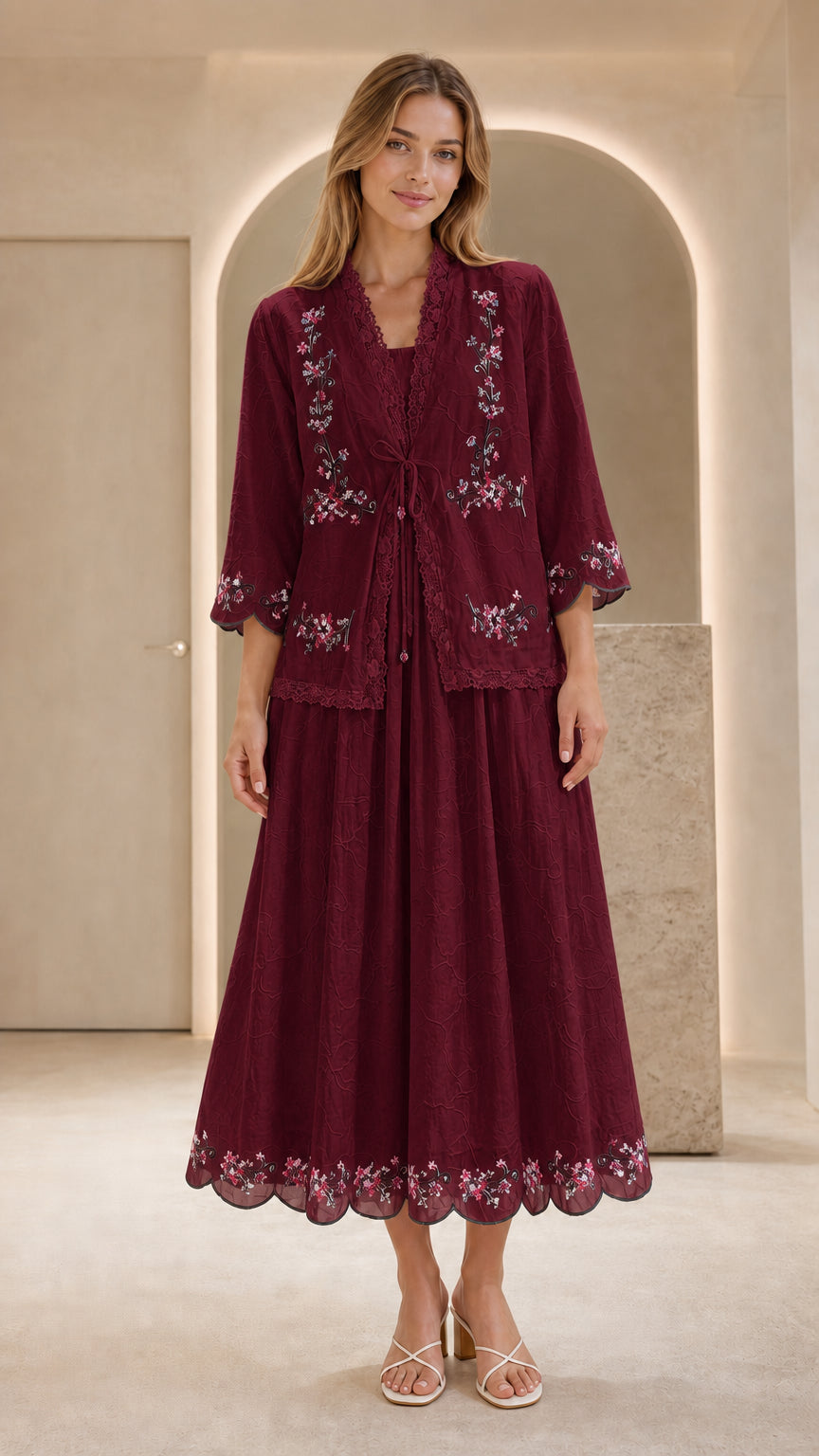 Front view of model wearing burgundy embroidered two-piece dress set